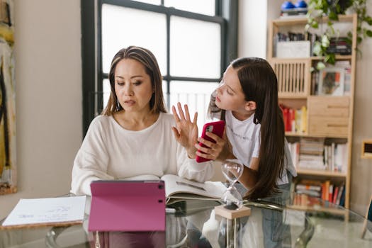 A mother and daughter interact with technology while at home, showcasing family dynamics.