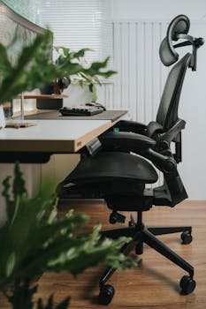 Sleek home office featuring an ergonomic chair near a minimalist desk setup.